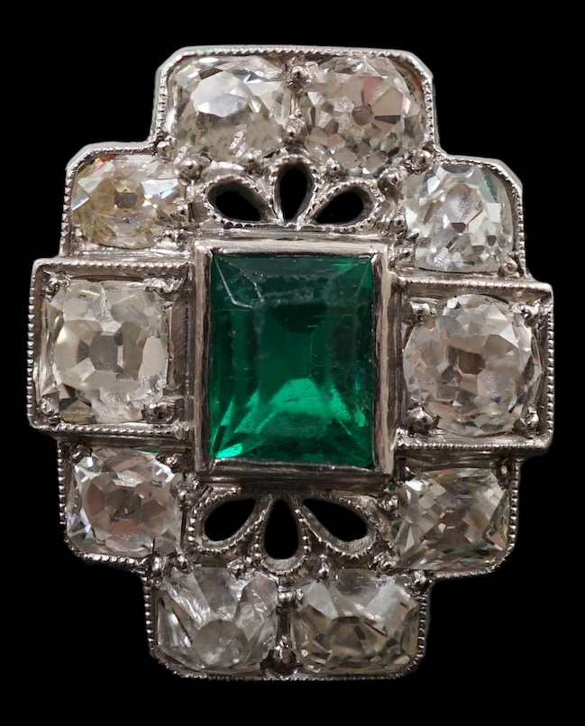 An early to mid 20th century white gold?, emerald and diamond cluster set stepped oval dress ring